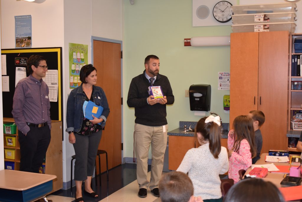 photo of dan and karen cashman presenting their program to first graders